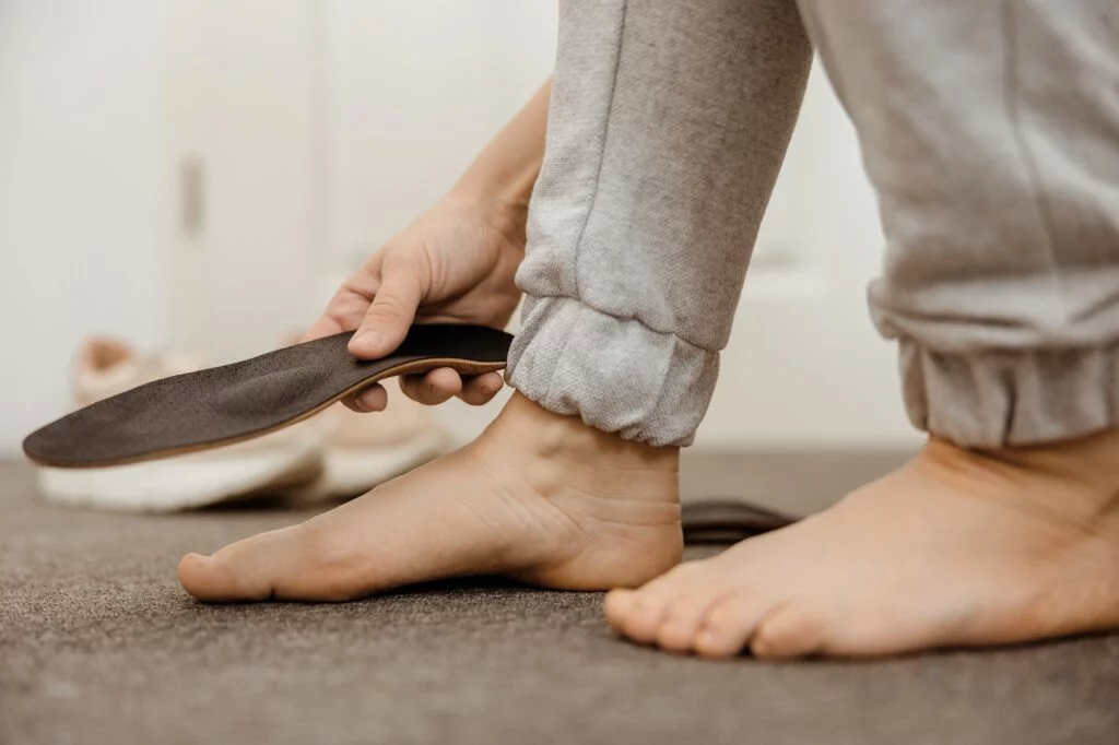 Hand fitting custom orthotic insole to bare foot