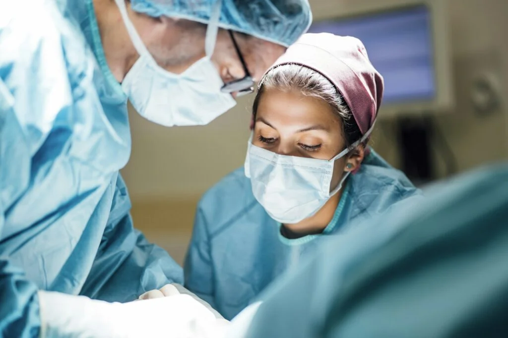 Surgical team performing foot surgery in an operating room
