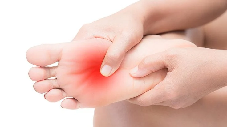 Hands pressing on foot showing nerve pain area
